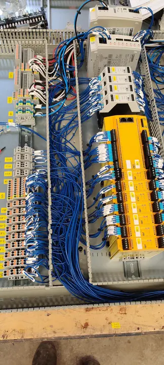 Control and safety cabinet with blue wiring loom and yellow safety relay