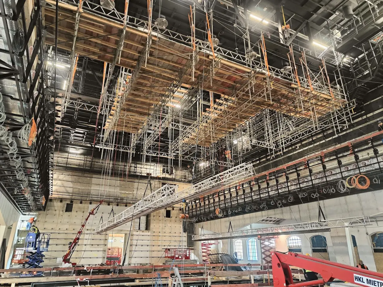 Theatre grid installation with suspended scaffolding decks during a venue get-in