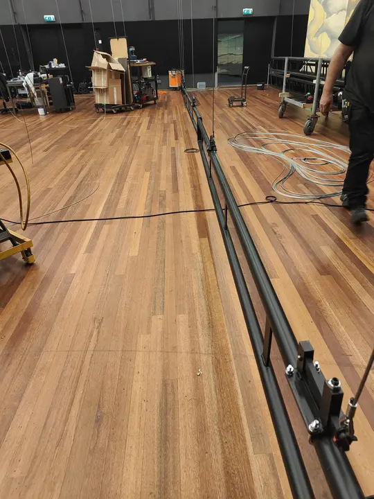 A fly-bar hung but not yet bolted during a venue install